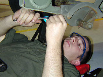 Staff Sgt. Aaron Lunderville lubricates a fitting on a generator. He’s part of a team that hit an in-commission rate of 100 percent on their aerospace ground equipment -- the first time that’s happened for his unit in at least four years.
