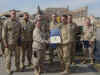 332 Expeditionary Maintenance Group's (EMXG) "Sharp Saber Team of the Month," Feb 2005 - 332 EMXG Commander, Col Dicks, presents a certificate to AGE Section Chief, TSgt Michael Gosik. In background are (left to right): SSgt Steven Peters, SSgt Reginald Peck, SSgt Nathan Corrado, SrA Daniel MacCallum, A1C Todd Spencer, A1C Christan Rouse.